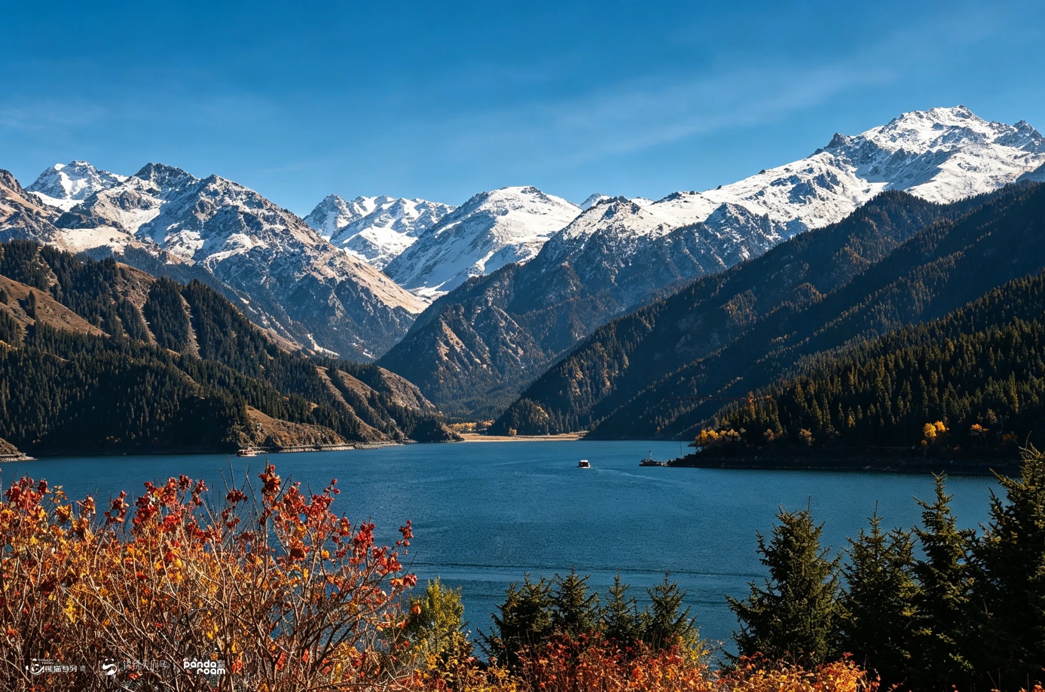 红叶前景后的蓝色湖泊、深色山坡与远处雪山